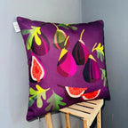 Decorative pillow with fig pattern on a wooden stool against a gray wall