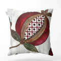 Decorative pillow with a pomegranate design on a white background
