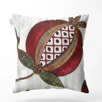 Decorative pillow with a pomegranate design on a white background