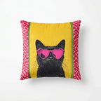 Pillow with a black cat wearing pink sunglasses on a yellow background