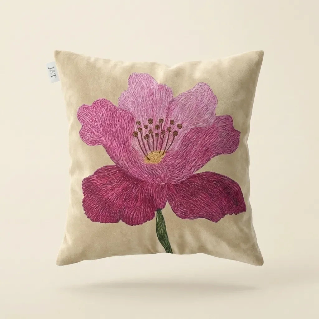 Decorative pillow with a pink flower design on a beige background