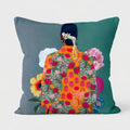 Decorative pillow with a colorful backless dress design on a gray and teal background