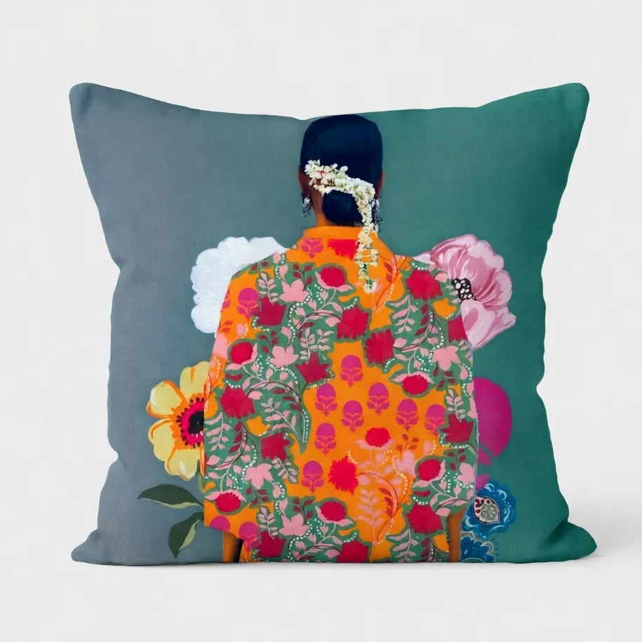 Decorative pillow with a colorful backless dress design on a gray and teal background