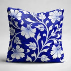 Decorative pillow with white floral pattern on a blue background